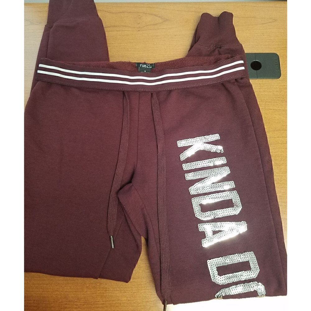 Rue21 Small Burgundy sweatpants with"Kinda Don't Care" in silver sequins down t